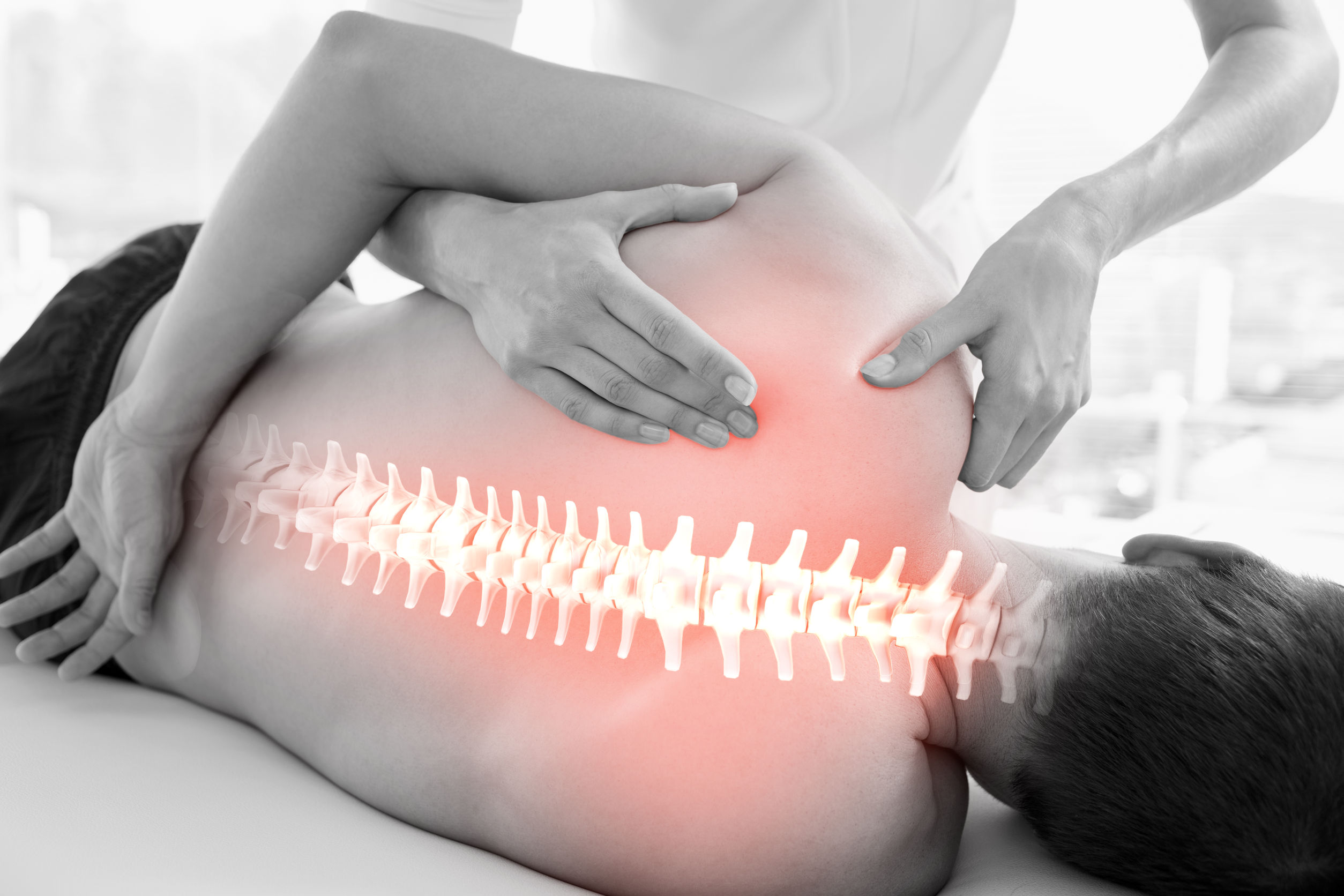 42112199 - Digital Composite Of Highlighted Spine Of Man At Physiotherapy