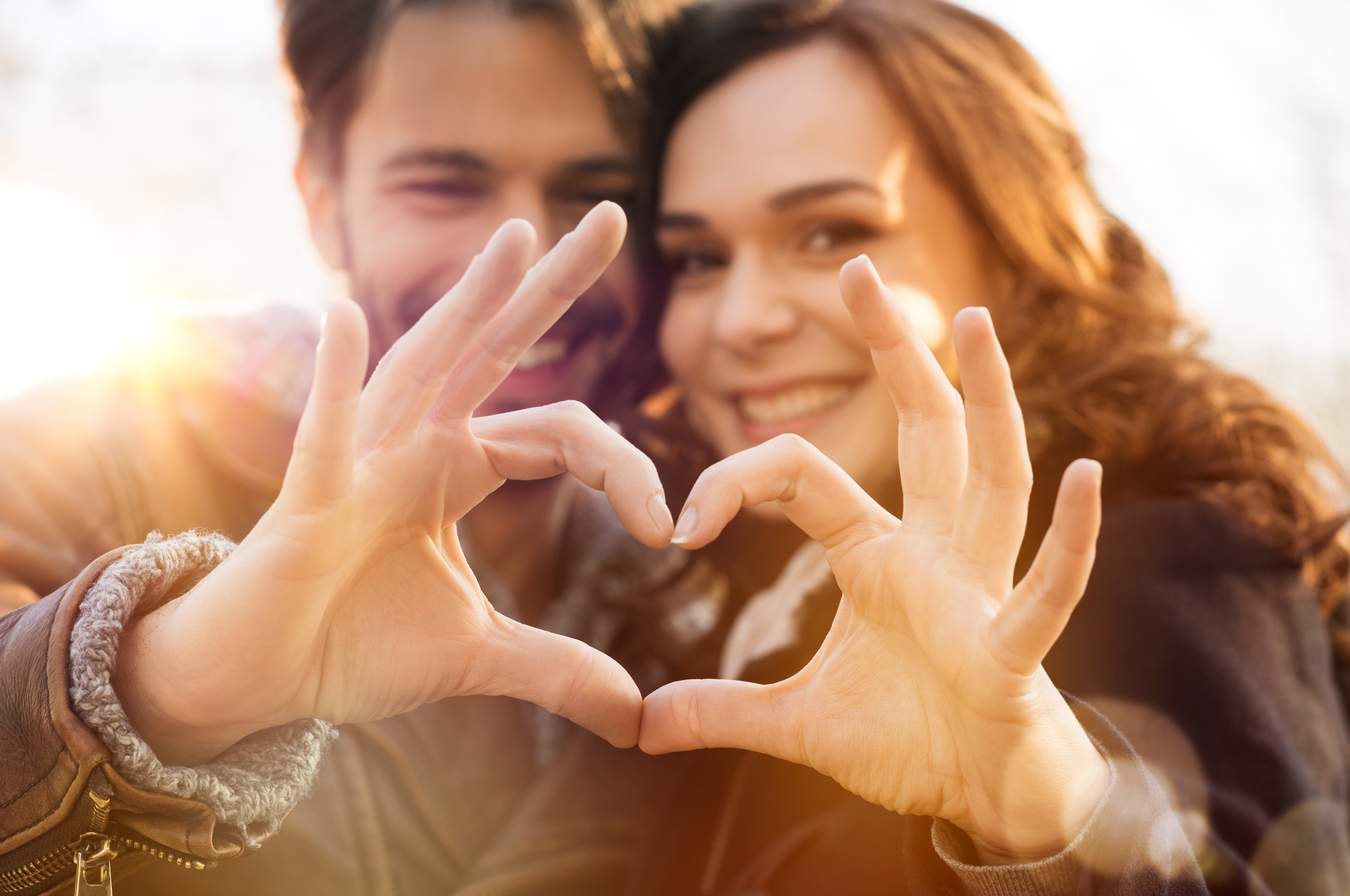 Closeup Of Couple Making Heart Shape With Hands